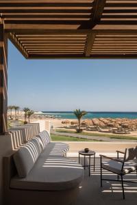 a living room with a couch and chairs and the beach at JAZ Elite Riviera in Port Ghalib +68 photos