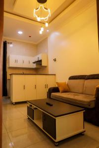 a living room with a couch and a coffee table at Martin Aviator Apartment in Kigali