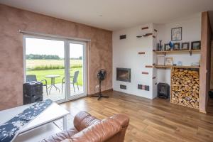 a living room with a couch and a table and a fireplace at Sepa puhkemaja in Pärnu