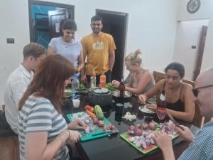 a group of people standing around a table with food at FREEDOM HOUSE, Munroe Island , Kollam - A Backpackers Hostel in Munroe Island