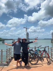 two people posing for a picture on a pier with bikes at FREEDOM HOUSE, Munroe Island , Kollam - A Backpackers Hostel in Munroe Island