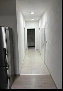an empty hallway with a hallway leading to a door at Apartment Eneya in Pazarić