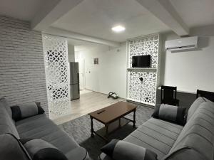 a living room with a couch and a table at Apartment Eneya in Pazarić