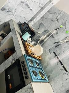 an overhead view of a kitchen with a stove top at L'évasion-Royale in Thiès