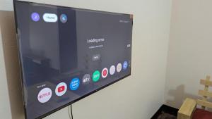 a flat screen tv hanging on a wall at CJ Apartments in Kapchorwa +29 photos