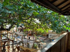 a street sign on a fence next to a tree at My happy place loft gili air in Gili Islands +16 photos