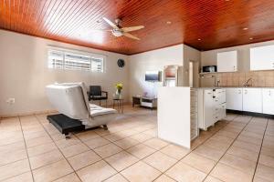 a living room with a ceiling fan and a chair at Hephzibah Manor in Alberton