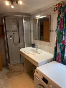 a bathroom with a sink and a shower and a sink at Haus Wäscher in Hirschegg +40 photos