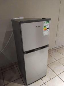 a small refrigerator sitting in a kitchen at Hephzibah Manor in Alberton
