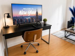 a desk with a television on it in a living room at Studio apart Time Square in New York