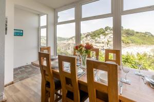 a dining room with a table and chairs and a window at 4 Bed in Looe oc-l30051 in Looe