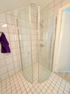 a shower with a glass door in a bathroom at Airport Villa Near Helsinki Airport for 10 Guests in Vantaa