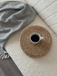 a cup of coffee sitting on top of a couch at Характер парк in Hatne +157 photos