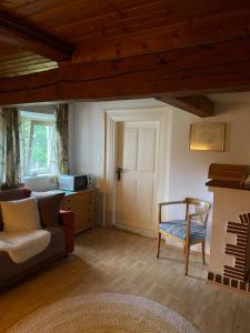 a living room with a couch and a chair at Haus Wäscher in Hirschegg