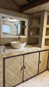 a bathroom with a sink and a large mirror at My happy place loft gili air in Gili Islands