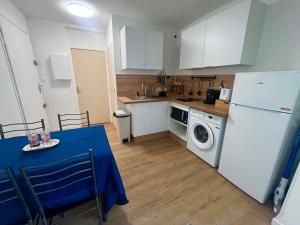 a kitchen with a white refrigerator and a washing machine at Appartement 61 in La Ciotat