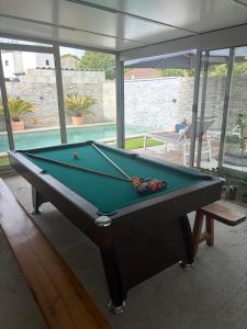 a pool table in a room with a view of the water at Evasion Suite parentale in La Couronne