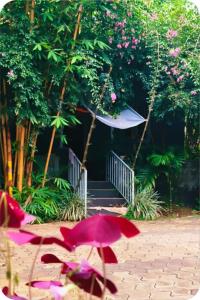 a pink umbrella sitting on a patio with a staircase at The bharani villa in Pulpally