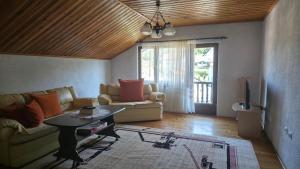 a living room with a couch and a table at Holiday Home Nana in Bugojno