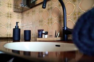 a bathroom counter with a sink and a faucet at Chambre confort - Le Boudoir in Hendaye