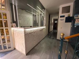 a lobby of a building with a marble counter at Hotel Monarca in Medellín +41 photos