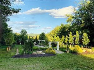 a garden with a gazebo in the grass at Scenic Vista Inn in North Conway