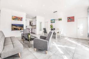 a living room with a couch and a table at Villa Adriatic Pearl in Dubrovnik