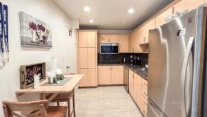 a kitchen with a stainless steel refrigerator and a table at THE TIDES 1 bedroom apt 8th floor WE ARE ON THE BEACH in Hollywood