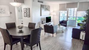 a dining room and living room with a table and chairs at THE TIDES 1 bedroom apt 8th floor WE ARE ON THE BEACH in Hollywood