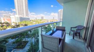 a balcony with a table and chairs and a view of the city at THE TIDES 1 bedroom apt 8th floor WE ARE ON THE BEACH in Hollywood