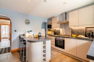 a kitchen with white cabinets and a counter top at 3 Bed in Sandsend oc-wa081 in Sandsend