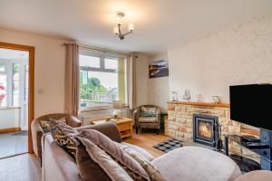 a living room with a couch and a fireplace at 3 Bed in Sandsend oc-wa081 in Sandsend