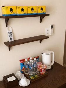 a table with a tray of water bottles on a shelf at Soho Boutique in Quảng Ngãi