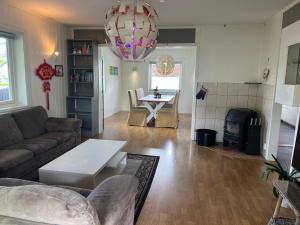 a living room with a couch and a table at guesthouse -Åndalsnes in Åndalsnes +23 photos