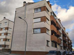 a tall building with cars parked in front of it at Destino eclipse Burgo de Osma in El Burgo de Osma