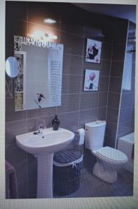 a bathroom with a sink and a toilet at Destino eclipse Burgo de Osma in El Burgo de Osma