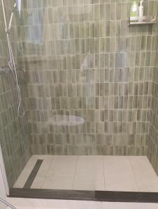 a bathroom with a shower with a tiled floor at Prie De Mä in Genoa