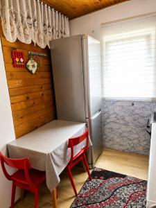 a small kitchen with a table and a refrigerator at Apartment Aleksić in Žabljak