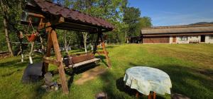 a wooden gazebo with a table in a yard at Casa Danut in Vidra