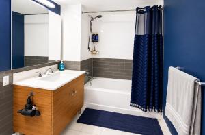 a bathroom with a white tub and a sink at Studio apart Time Square in New York +6 photos
