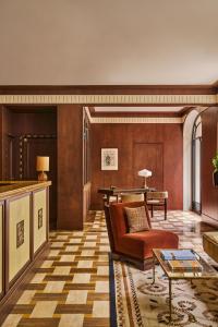a living room with a couch and a table at Hôtel Madison in Paris