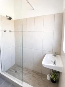 a bathroom with a shower and a sink at Die Ou Lady - Dwarskersbos in Velddrif +19 photos