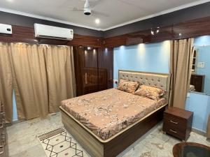 a bedroom with a bed in a room at Prakash Bhawan in Darbhanga
