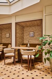 a dining room with a table and chairs at Hôtel Madison in Paris