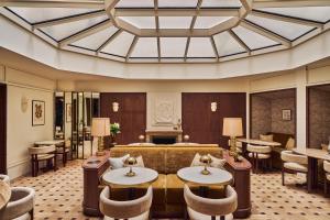 a hotel lobby with a couch and tables and chairs at Hôtel Madison in Paris +56 photos