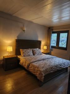 a bedroom with a large bed and a window at The Jasmine House - Ayubia in Ayubia