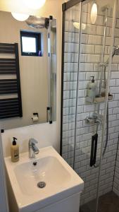 a bathroom with a sink and a shower at Landbrot Guesthouse in Kirkjubæjarklaustur