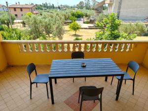 a blue table and chairs on a balcony at La Terrazza in Carrao