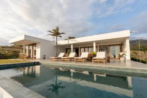 a villa with a swimming pool and a house at Jama Campay Hotel by Otium in Los Camarones