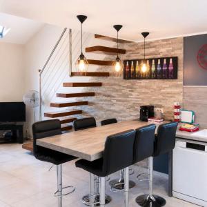 a dining room with a wooden table and black chairs at Appartement de vacances au 1er étage 45m2 in Antibes
